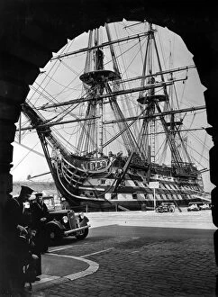 Ship Collection: HMS Victory the flagship of the fleet framed in an arch in Portsmouth dockyard