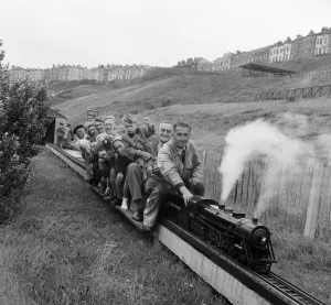 Holiday makers enjoying a ride on a miniature train. Scarborough, North Yorkshire Holiday makers enjoying a ride on a miniature train. Scarborough, North Yorkshire
