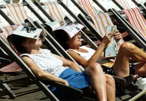 Holidays Blackpool couple sunbathe in deckchairs Holidays Blackpool couple sunbathe in deckchairs