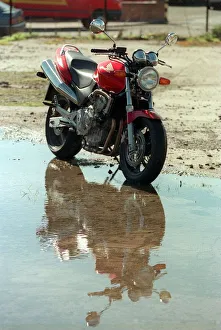 The Honda Hornet 600CC Motorbike April 1998 reflecting in water puddle The Honda Hornet 600CC Motorbike April 1998 reflecting in water puddle