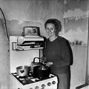 Housewife cooking dinner in her kitchen at home. December 1969 Z11805-001 Housewife cooking dinner in her kitchen at home. December 1969 Z11805-001