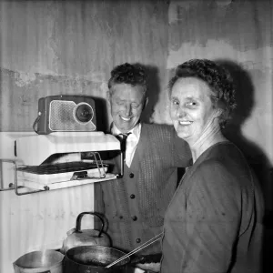 Housewife cooking dinner in her kitchen at home with her husband Housewife cooking dinner in her kitchen at home with her husband