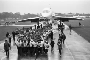 Hundreds of people were drenched by heavy rain as they pulled Concorde around an airfield Hundreds of people were drenched by heavy rain as they pulled Concorde around an airfield
