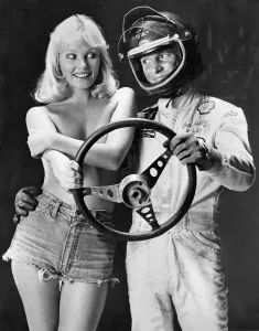 Ian Ashley and Angela Jay pose together holding a steering wheel Ian Ashley and Angela Jay pose together holding a steering wheel