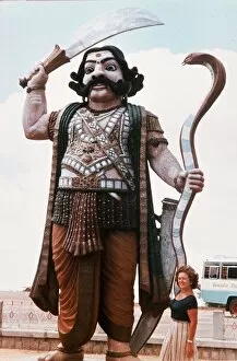 India Demon Mahisha with sword and cobra guards the approach to a hill temple near Mysore