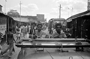 Images Dated 13th June 1971: India - War Scenes - 1971 men driving through a street armed with guns