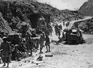 Keren Collection: Indian army soldiers at a junction of roads where an Italian lorry can be seen blown