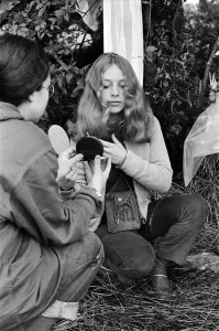 Isle of Wight Festival. A girl combing her hair. Left to right Isle of Wight Festival. A girl combing her hair. Left to right