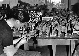 J. McCarthay of the RAF puts the finishing touches to a toy boat J. McCarthay of the RAF puts the finishing touches to a toy boat