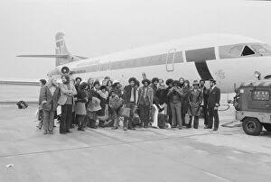 The Jackson Five pop group stand beside their plane as they arrive at London airport