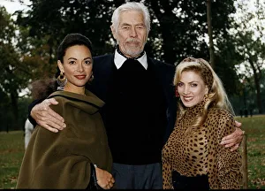 00138 Gallery: James Coburn American actor stands with his arms around Paula Murad on his left