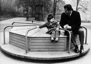 James Garner American actor on roundabout with child 1964 James Garner American actor on roundabout with child 1964