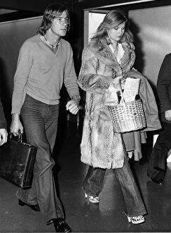 Images Dated 12th October 1977: James Hunt with girlfriend Jane Birbeck at Heathrow Airport after returning from Canada