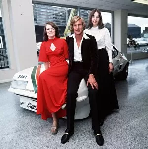 James Hunt racing driver May 1976 sitting on bonnet of rally car with female fans