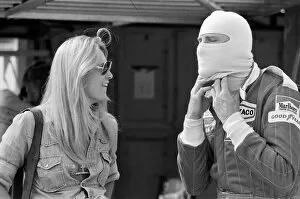 Images Dated 17th July 1976: James Hunt talks to a female friend at a practice day for the British Grand Prix held at