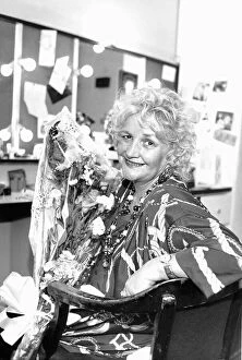 Jean Boht actress sits in dressing room holding bouquet of flowers May 1989