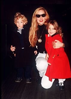 Images Dated 4th December 1988: Jerry Hall model with children Elizabeth Scarlet and James at Heathrow airport leaving