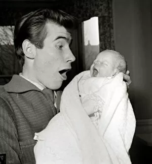 Holland Park Collection: Jim Dale holds his new born baby girl Jane Belinda after her birth at a nursing home in