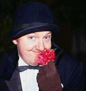 Images Dated 1st September 1986: Jimmy Cricket comedian September 1986 sniffing smelling a flower