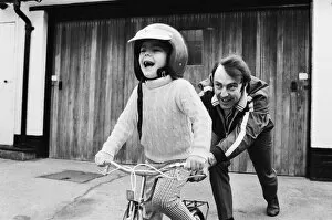 Images Dated 16th April 1970: Jimmy Greaves pushing his 4-year old son Andrew, wearing his fathers crash helmet