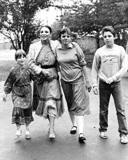 Images Dated 1st August 1980: Joan Collins with children Katyana Kass, Tara Newley and Sacha Newley walking in park