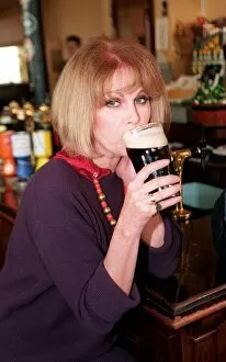 Images Dated 18th October 1995: Joanna Lumley actress swops the bolly for a pint today to launch a new pub