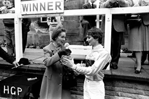 Jockey Walter Swinburn receives a winners trophy at Gosforth Park Racecourse, Newcastle