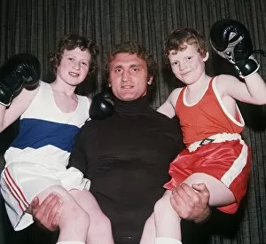Joe Bugner boxer lifting up children December 1975