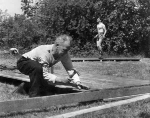 Joe Gans hammers some boards together. While Walter does some skipping Joe Gans hammers some boards together. While Walter does some skipping