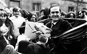 Images Dated 20th April 1971: John Cleese at St Andrews ready for a drive around with a piglet