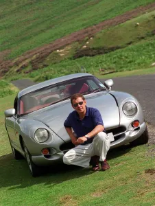John Clelland sitting in front of a silver grey TVR Cerbera car August 1997 John Clelland sitting in front of a silver grey TVR Cerbera car August 1997