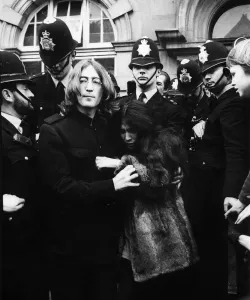 John Lennon with Yoko Ono surrounded by policemen as they leave Marylebone Magistates John Lennon with Yoko Ono surrounded by policemen as they leave Marylebone Magistates