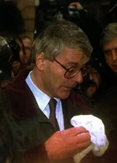John Major MP wiping his face whilst in Chester after a egg throwing incident diring