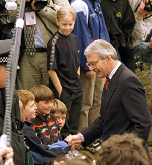 Images Dated 9th January 2006: John Major shaking hands with small boy during his visit to Gretna Green April 1997