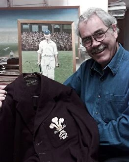 Images Dated 22nd June 1998: John McKenzie who run a shop of Cricket Memorabilia holds a jacket which was worn by Jack