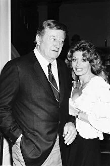 Images Dated 1st January 1974: John Wayne with Miss Toni Holt who asked him to do a nude pin-up for her magazine