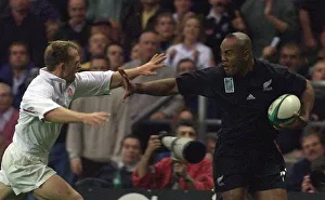 Jonah Lomu of New Zealand Oct 1999 hands off Matt Dawson of England on his way to Jonah Lomu of New Zealand Oct 1999 hands off Matt Dawson of England on his way to