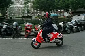 Jonathon Ross TV Presenter August 1998 Riding his Union Jack painted Vespa scooter