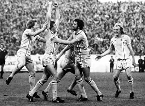 The joy of scoring...Tommy Hutchison, arms held high, is mobbed by delighted City