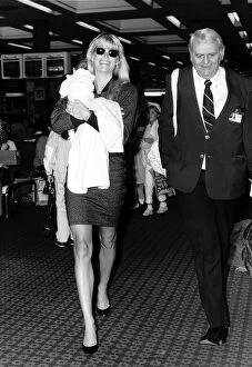00054 Gallery: Kathy Emberg with daughter of Rod Stewart Ruby walking through Heathrow airport