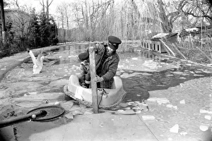 Keepers at Chessington Zoo chip the ice on the storks and ducks pond Keepers at Chessington Zoo chip the ice on the storks and ducks pond