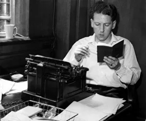 Keith Waterhouse Daily Mirror columnist July 1957 Sitting at typewriter reading Keith Waterhouse Daily Mirror columnist July 1957 Sitting at typewriter reading