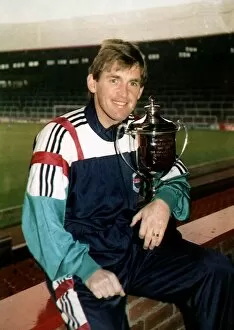 Images Dated 7th January 1997: Kenny Dalglish former Footballer and Football Manager holding Man of the Decade trophy