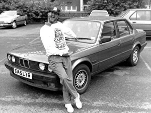 Images Dated 21st July 1989: Kenny Everett sitting on bonnet of his new BMW car 21 / 07 / 1989