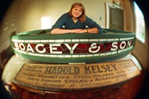 Kirkleatham Old Hall Museum curator Leigh Lampard with two of the old shop signs Kirkleatham Old Hall Museum curator Leigh Lampard with two of the old shop signs