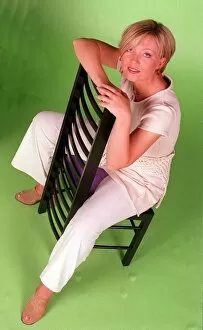 Images Dated 17th June 1996: Kirsty Young TV Presenter Channel 5 sitting on chair wearing white trousers looking up