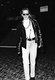 Images Dated 5th September 1989: Kylie Minogue singer actress in dark glasses and leather jacket at Heathrow Airport