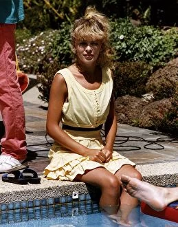 Images Dated 27th January 1988: Kylie Minogue in the TV programme set of Neighbours, were she is sitting besides the pool