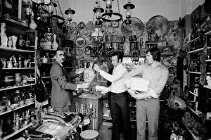 Images Dated 15th May 1973: Leeds United players buying gifts in a local shop as they take a walk around the town of