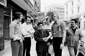 Images Dated 15th May 1973: Leeds United players meet a local man with a huge moustache as they take a walk around